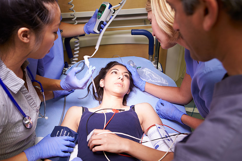 Doctors around a patient in the emergency room